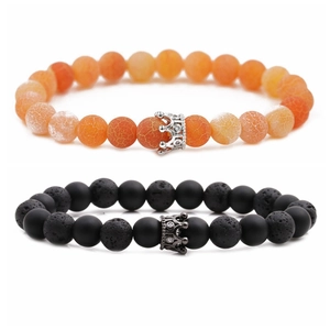 Detail view of 8mm orange crackle stone and matte black beaded bracelets with crown charms