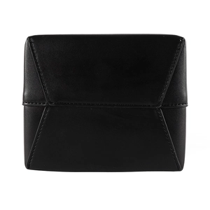 Close-up of geometric puzzle stitching detail on a black matte leather crossbody bag
