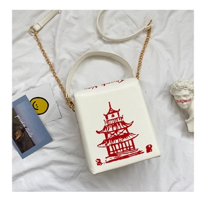 Detail of creative take-out box bag with red pagoda print and gold chain strap