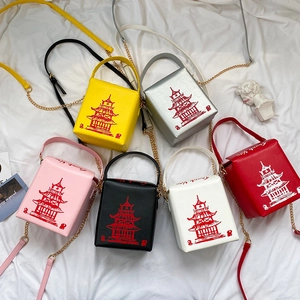 Flat lay of Chinese takeout box style crossbody bags in six colors with pagoda print