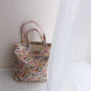 Detailed macro view of a floral cotton tote bag with soft morning light and sheer curtains