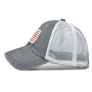 Detailed side view of washed cotton baseball cap with distressed holes and mesh back