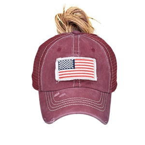 Detail of burgundy ponytail baseball cap with American flag patch and mesh back