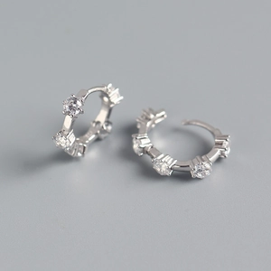 Macro view of S925 sterling silver hoop earrings with five round-cut prong-set zircons