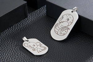 Detailed view of stainless steel pendants with mouse and snake zodiac engravings