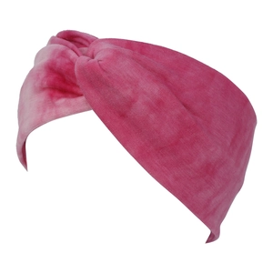 Detail showing the elastic twist knot design and tie-dye texture of the pink headband
