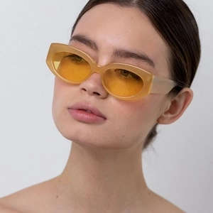 Retro cat-eye sunglasses with oval beige frame and yellow transparent lenses for women