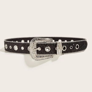Detail of black glitter belt with silver rhinestone buckle and metal eyelets in Y2K style