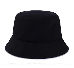 Flat lay close-up of a minimalist black cotton bucket hat with a classic round crown design