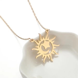 Long gold sweater chain featuring a sun pendant with hollow moon and star designs