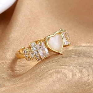 Adjustable 18K gold-plated ring with heart-shaped cat eye stone on champagne silk