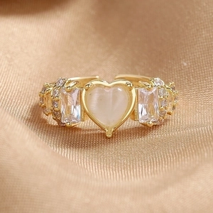 Adjustable gold ring featuring heart-shaped cat-eye stone and zircon accents on satin