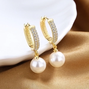 Elegant 18K gold plated pearl drop earrings with micro-pave crystals on white silk