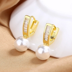 Elegant gold geometric earrings featuring cubic zirconia and hanging white pearls