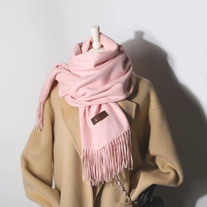 Pink knitted cashmere-feel scarf with elegant fringe and premium leather brand tag