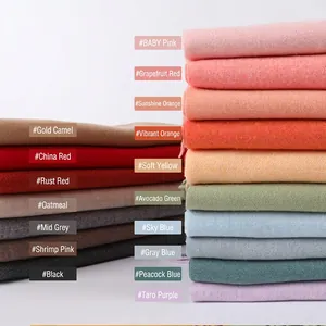 Stack of 17 colorful solid cashmere scarves with fringes for winter warmth and style