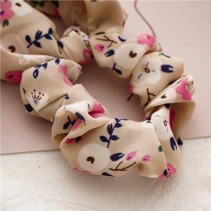Floral chiffon scrunchie with pink flowers and ribbons for stylish ponytails