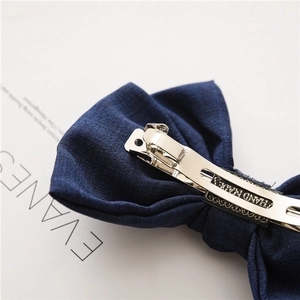 Handmade navy blue fabric bow hair clip with silver metal spring barrette for women