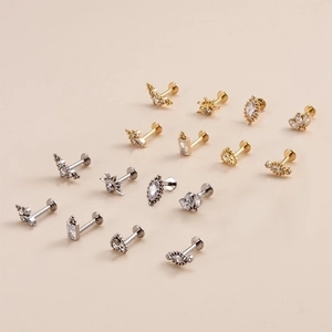 16-piece titanium piercing set featuring gold and silver studs with zircon heart designs