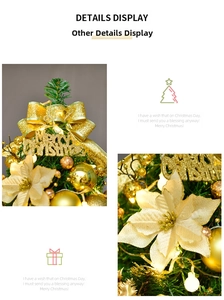 Detail of gold Christmas tree decorations including Merry Christmas sign and warm LED lights
