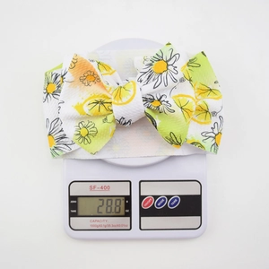 Detailed view of lightweight infant headband weighing 28.8g with lemon and daisy print