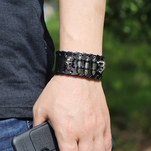Punk leather bracelet for men featuring silver skull and bullet charms with woven edges