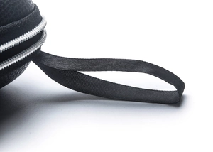 Macro detail of black lychee leather sunglass case with silver zipper and nylon handle