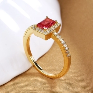 Luxury gold ring with rectangular red gemstone and white pavé cubic zirconia accents