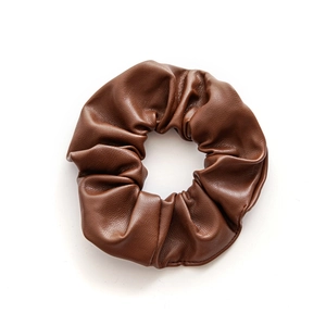 Minimalist brown PU leather scrunchie hair tie with premium texture on white background