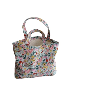 Floral canvas tote bag with colorful flower pattern and double handles for daily use