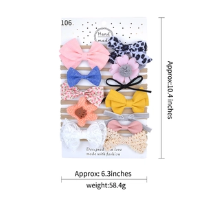 Set of 10 assorted cotton baby headbands with large bows and floral patterns on card