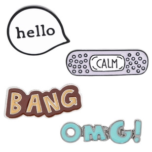 Detail view of colorful enamel pins set including Hello, Calm, Bang and OMG designs