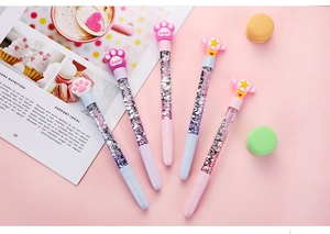 Macro view of five-piece cartoon gel pens with liquid glitter and cat paw toppers