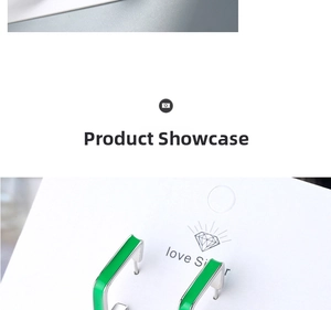 Detailed close-up of rectangular green enamel drop earrings with a silver metal base
