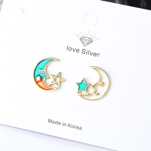 Stylish gold-tone moon and star stud earrings with blue-orange gradient enamel finish