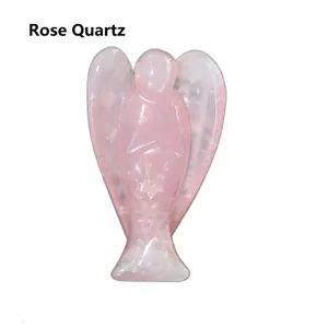 Macro shot of hand-carved natural rose quartz angel sculpture with detailed wings