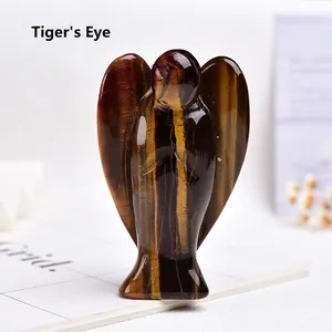 Macro detail of hand-carved tiger eye stone angel figurine with natural chatoyant texture