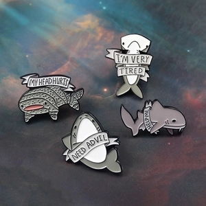 Set of four cartoon shark enamel pins with humorous ribbons on star background