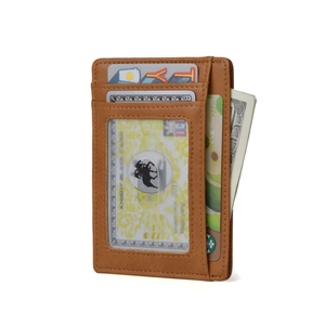 Macro detail of the slim brown leather wallet showing multiple card slots and clear ID window