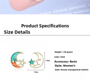 Detailed view of gold star and moon stud earrings showing 14mm size and 1.98g weight