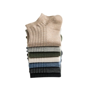 Stack of seven multi-colored men's rib-knit cotton ankle socks in neutral earthy tones