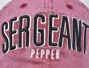 Close-up of 3D Sergeant Pepper embroidery on distressed washed cotton baseball cap