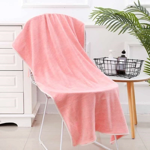Close-up of soft pink pineapple plaid coral fleece bath towel with high absorption texture