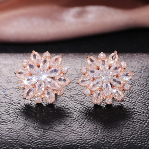 Macro detail of sunflower stud earrings with rose gold plating and clear cubic zirconia