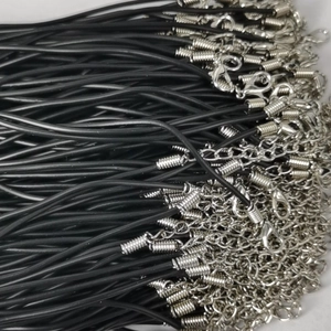 Close-up of bulk black wax cord necklace strings with silver lobster clasps and chains
