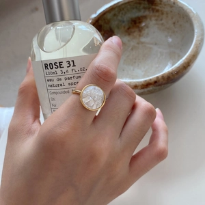 Detailed view of vintage gold 925 silver ring with white carved shell cameo relief