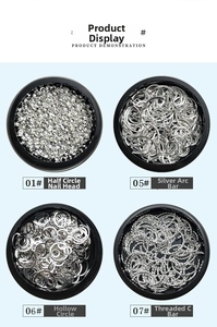 Detail of silver nail art studs including round, curved bar and hollow ring shapes