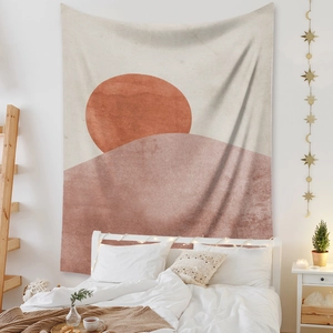 Bohemian sun and moon tapestry with abstract sun and hills hanging over a cozy bed