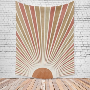 Detail of bohemian sun tapestry with terracotta geometric patterns on a white brick wall