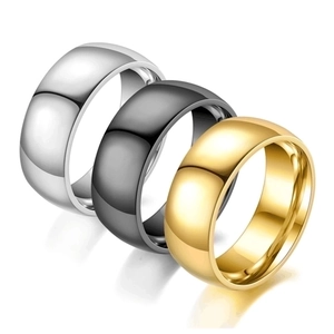 Three-piece ring set in silver, black, and gold with a polished mirror finish detail